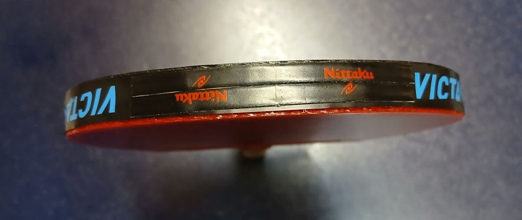 Nittaku Side Balancer attached near the tip of a table tennis racket